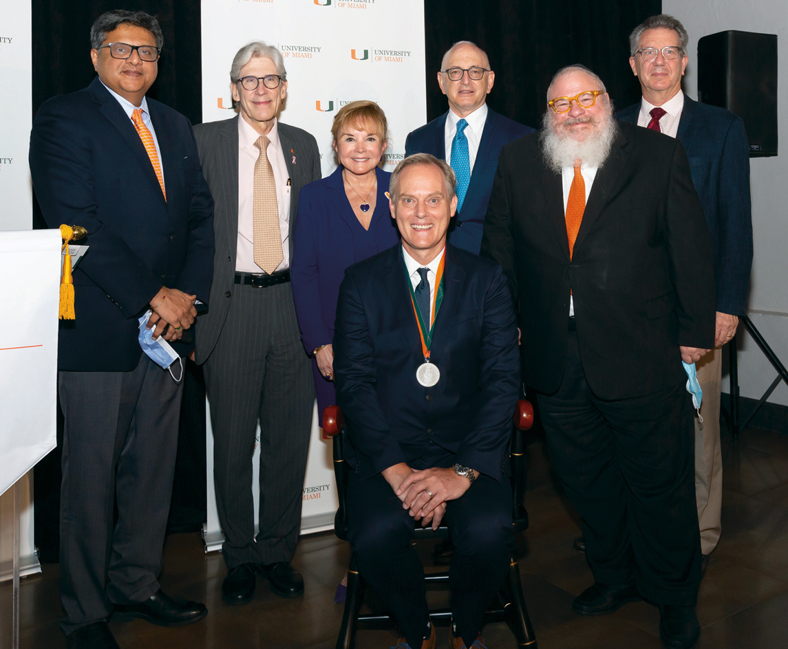 Photograph of C. Ola Landgren, M.D., Ph.D. (sitting) Winner of Paul J. DiMare Endowed Chair i Immunotherapy, poses with other team members who are standing around him.