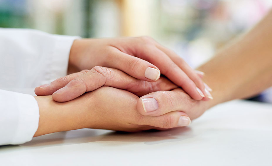 Two hands holding each other