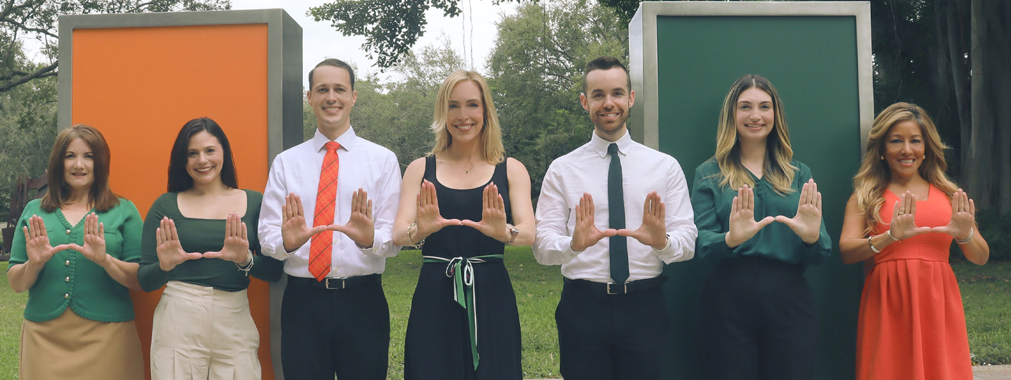 UHealth employees making a U with their hands