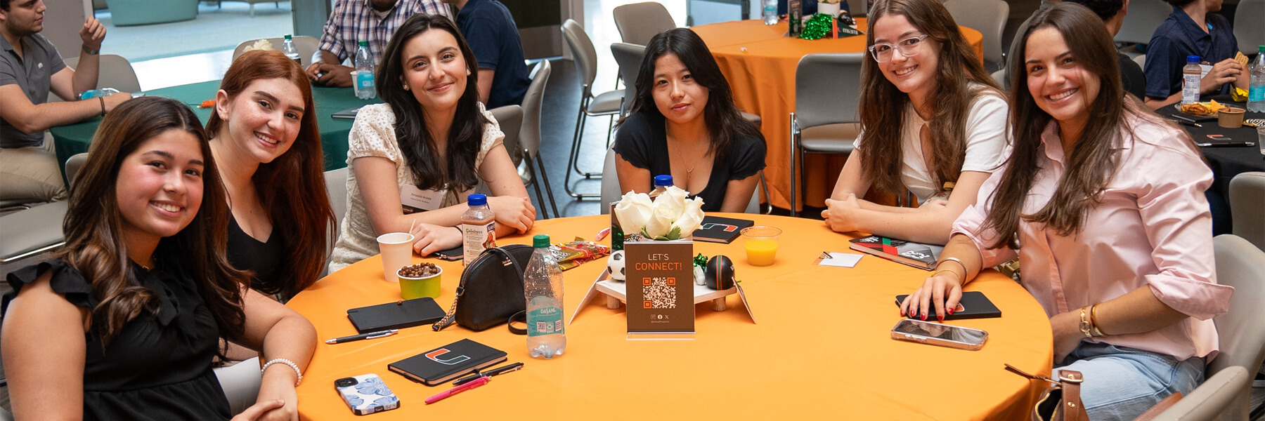 Six young girls sitting at a round table
