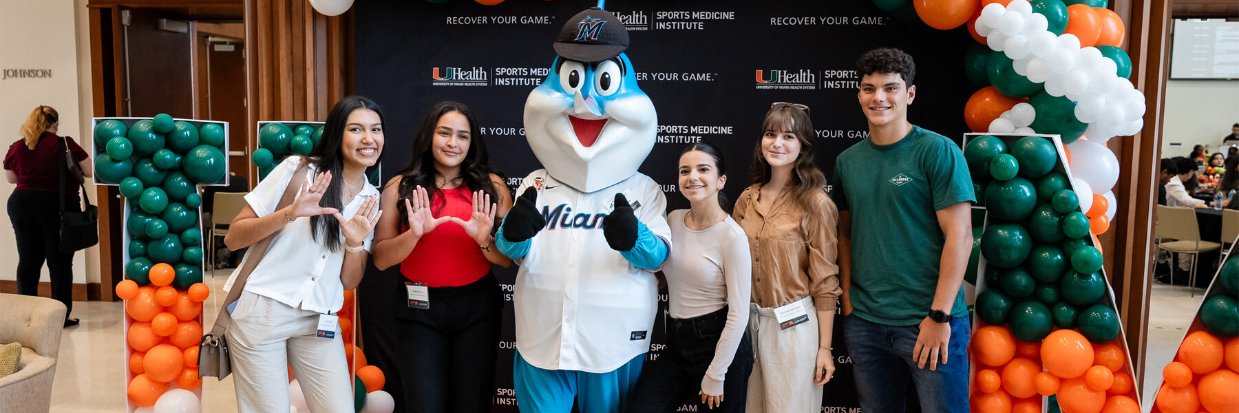 Several young students standing next to Billy the Marlin
