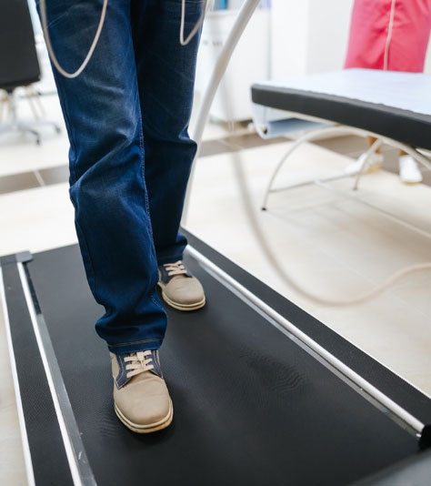 Man doing a stress test while walking on a treadmill