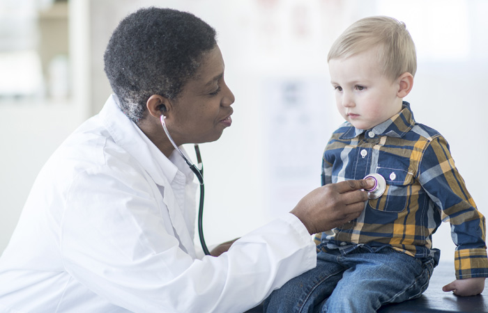Doctor Listening to a Child's Heartbeat