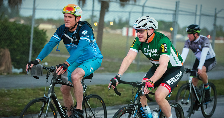 Stuart A. Miller (left), Former Chairman of the University of Miami Board of Trustees, cycles alongside Sylvester Director Stephen D. Nimer on the DCC Hurricanes Hundred route, which follows 100 miles through iconic Miami and Fort Lauderdale landscapes.