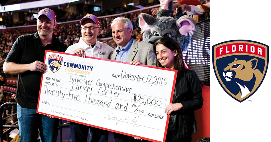 Sylvester Director Stephen D. Nimer, M.D., second from left, receives the Florida Panthers donation from Panthers co-owner Doug Cifu (second from right).
