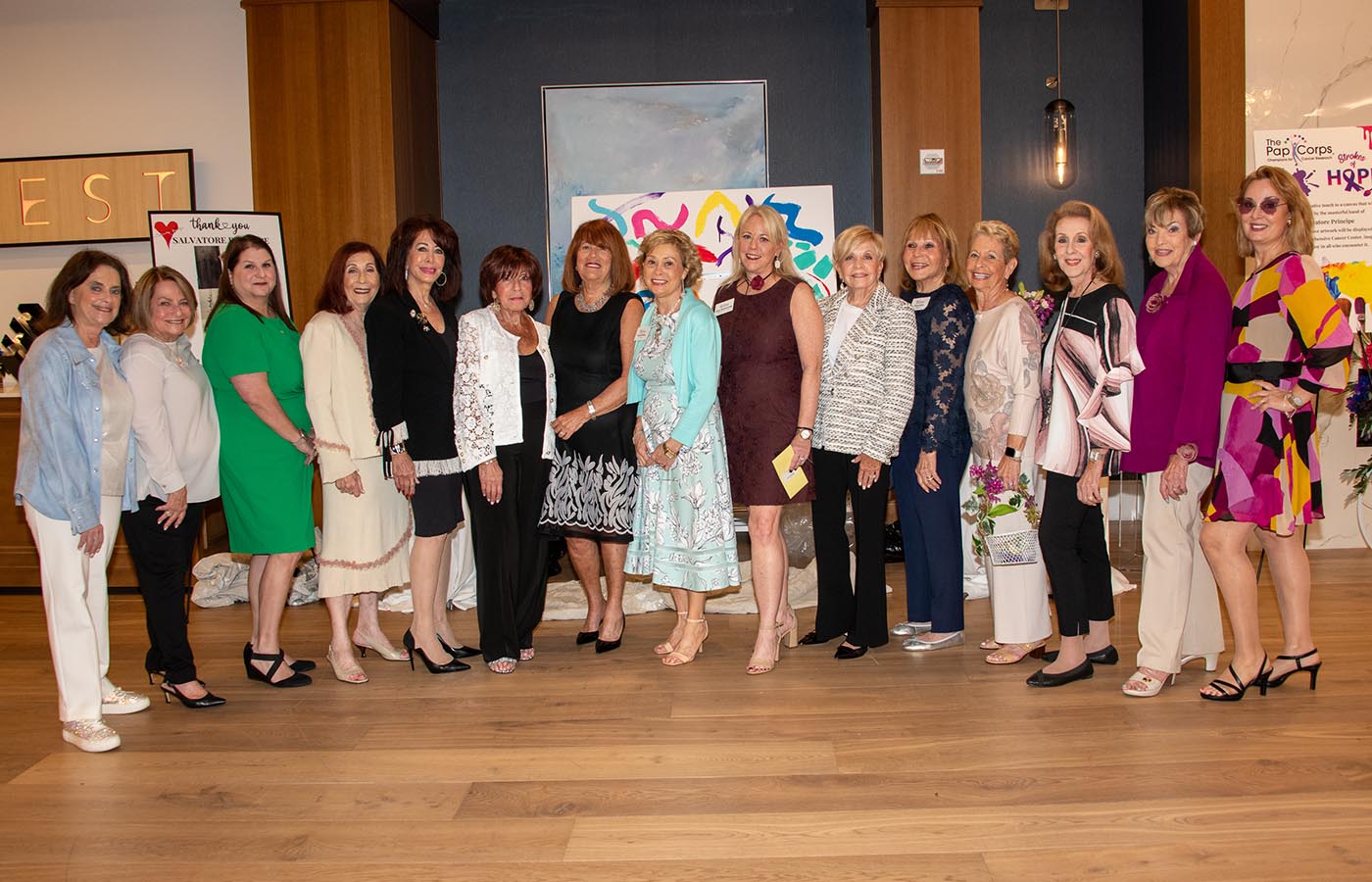 Susan Dinter (eighth from right) and Sally Berenzweig (seventh from the right) with the Art in the Park–A Gallery of Hope organizing committee. 