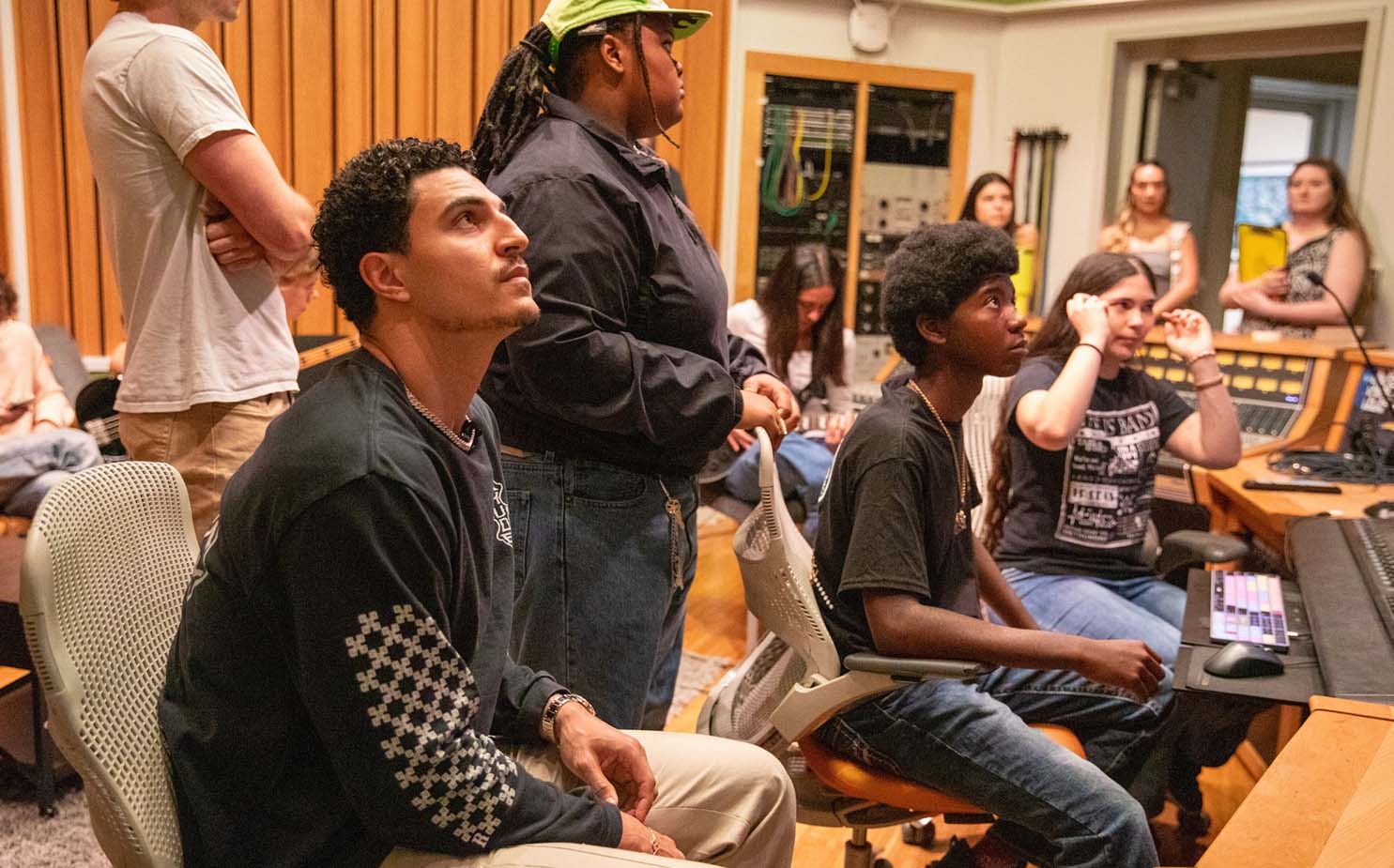 Jaelan Phillips watching MusicReach students he sponsored working in the Weeks Recording Studio at the Frost School.