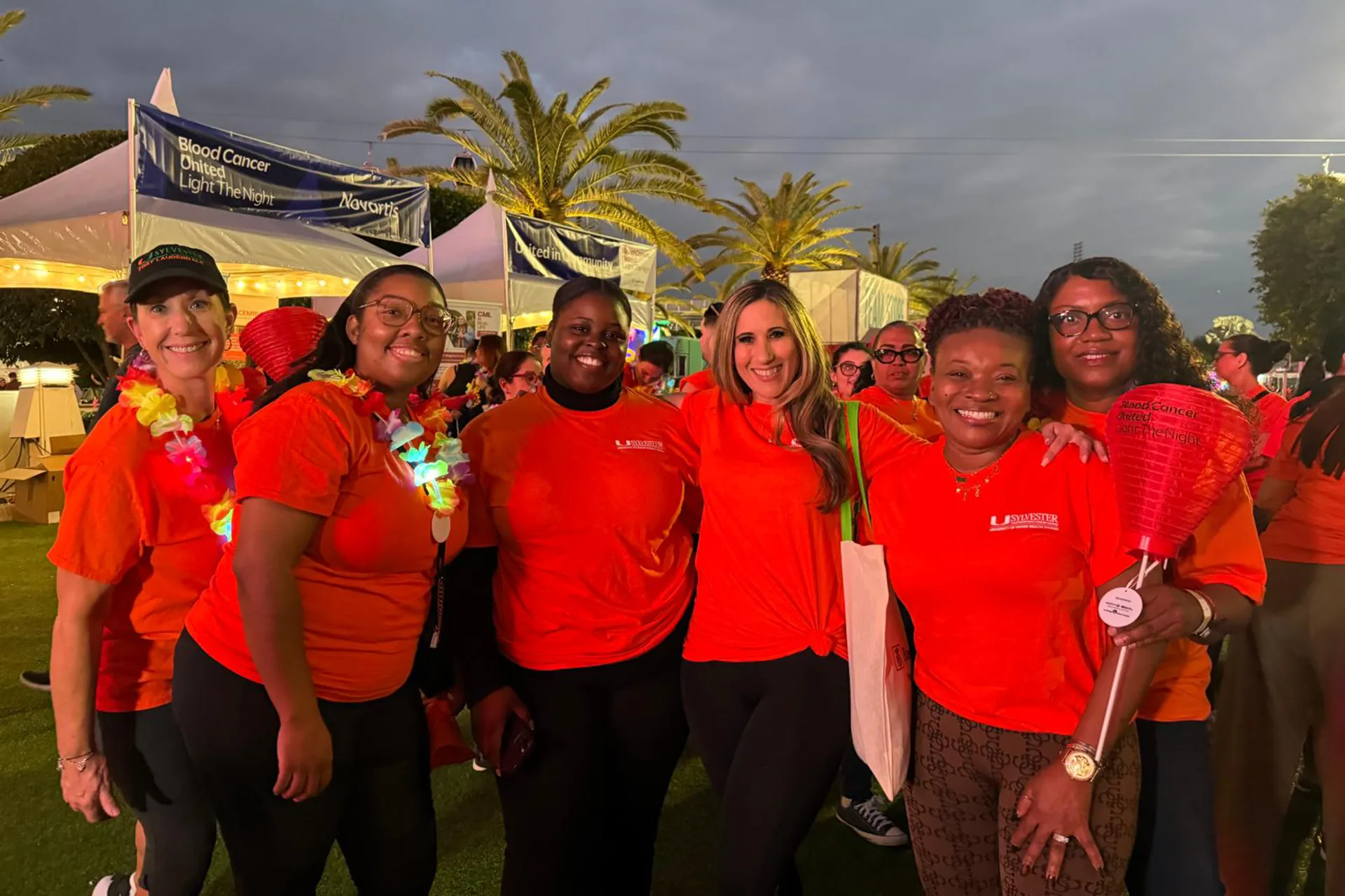 Sylvester staff pose at an outdoor event to benefit cancer causes