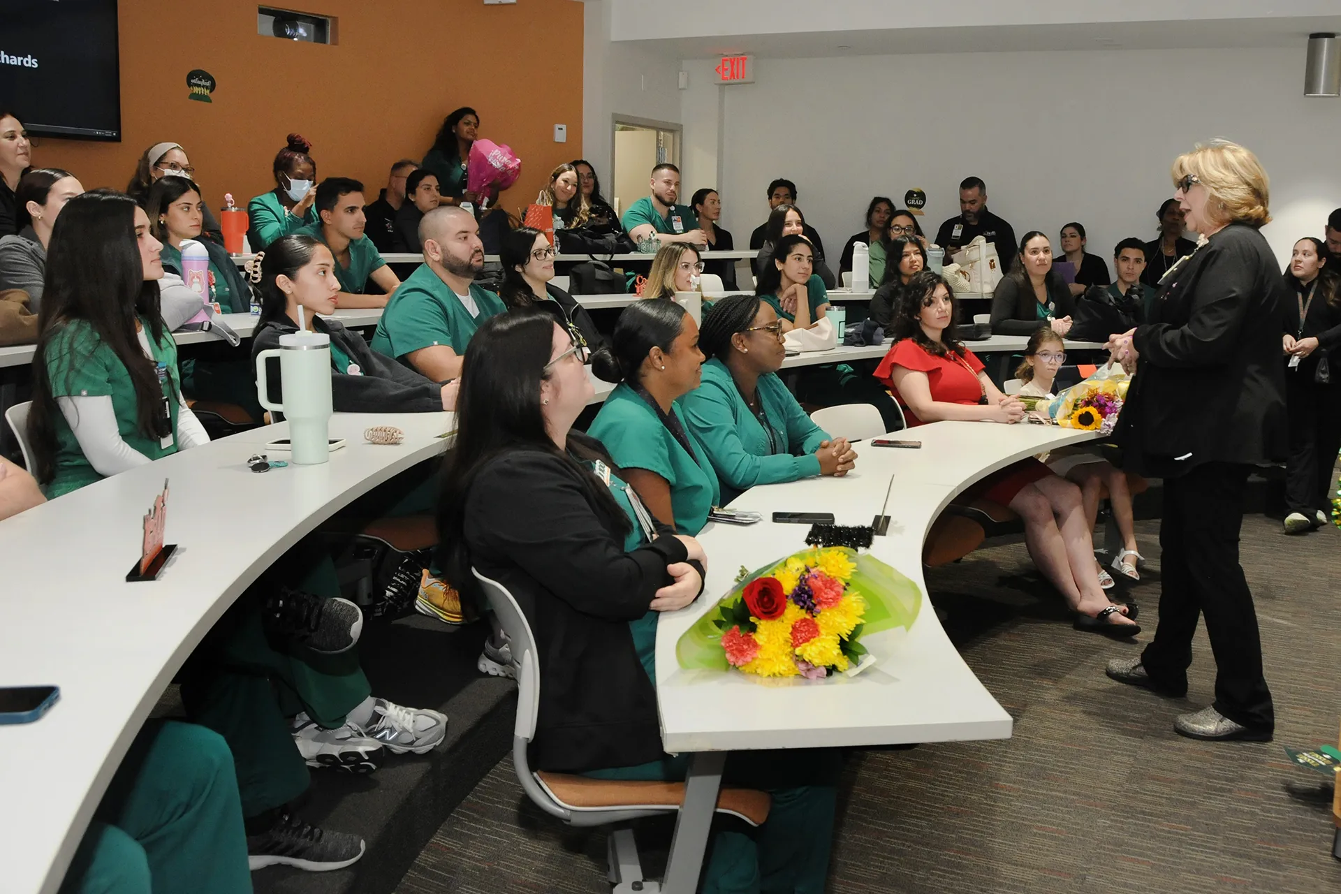 Group of residents listening to a speaker in a classroom