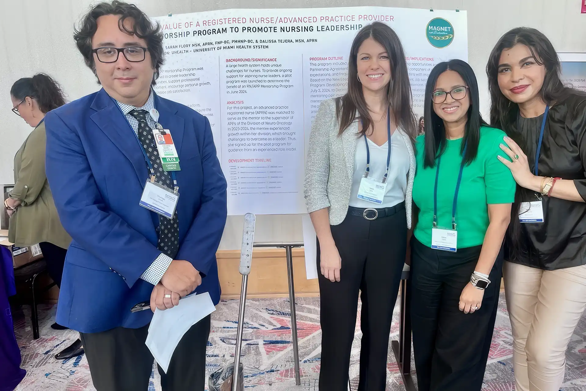 Nurses pose with a poster showing a program to promote nursing leadership