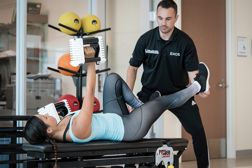 EXOS physician assisting in exercise.